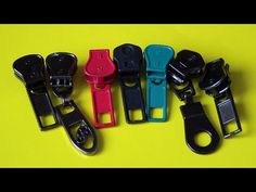 several different colored plastic clippers on a yellow surface