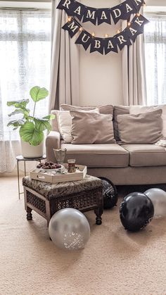 the living room is decorated with balloons and buntings that read rama mubara