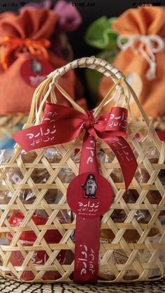 a basket filled with lots of chocolates on top of a wooden table next to other bags