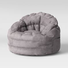 a grey bean bag chair sitting on top of a white floor