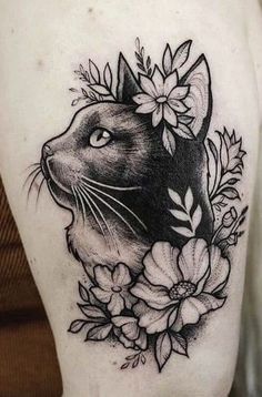 a black and white tattoo of a cat with flowers on it's back shoulder