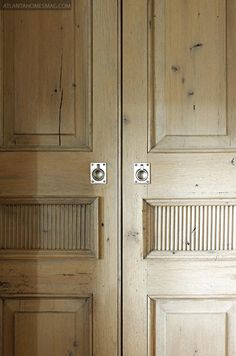 two wooden doors with metal handles and knobs