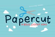 paper cut font with scissors on it and some pieces of paper flying in the air