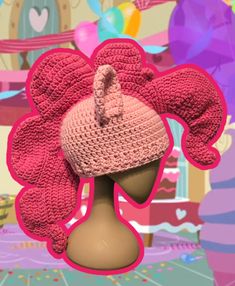 a pink knitted hat on top of a mannequin's head with balloons in the background