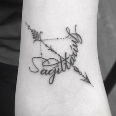 a black and white photo of a wrist tattoo with the word faith written in cursive writing