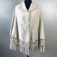 Brand: Artesania Celtex Alpaca Size: One Size Fits Most Features: Poncho / Cape Style No Built In Sleeves Beige / Tan Color High Neck - Can Be Worn Standing Up Or Laid Down Flat As Lapels Buttons All The Way Down The Front With Fabric Buttons Crochet Trim With Crochet Flower Accents Fringe / Tassels Soft And Warm Crochet Details Around The Trim Measurements: See Photos Fabric Content: Alpaca Preloved: Great Used Condition! No Flaws. Beige Fringed Poncho Shawl, Beige Fringe Shawl Poncho, Bohemian Cream Poncho With Fringe, Bohemian Alpaca Shawl One Size, Bohemian Alpaca Shawl Cape, Bohemian Alpaca Hand Knitted Shawl, Bohemian Alpaca Shawl, Bohemian Handwoven One-size Cape, Beige One Size Bohemian Poncho