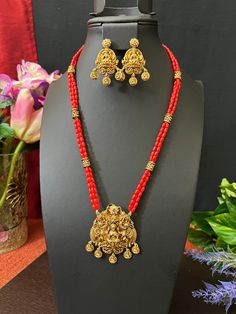 Goddess Lakshmi Coral Beads Haram/Antique Gold Finish / 3 Line Haram  with Matching Earrings/ 24 Inches Long/ Gift jewelry /Indian Jewelry This item is perfect to whear any time for parties and festivals! DETAILS: Includes Only  one haram and 2 Earrings . Necklace: 24 inches. Chain Closer . Weighs 1.80 oz ( 51 g).  Earrings: 1.8 inches Long  width; 1 inch wide  Material: Imitation gold Beads Coral Beads  Antique Gold Finish  Finish: Premium gold finish.  NOTE: I try my best to show you photos of my products as they appear in real life, but please note that variations in color occur due to differences in lighting and screen settings.  PRODUCT CARE: - Avoid contact with heat/fire, water, and chemicals such as perfumes or any sprays to prevent product damage.  - Store wrapped in butter paper, Beads Haram, Butter Paper, Fire Water, Gold Wedding Jewelry, 2 Earrings, Black Bead Necklace, Goddess Lakshmi, Jewelry Indian, Coral Beads