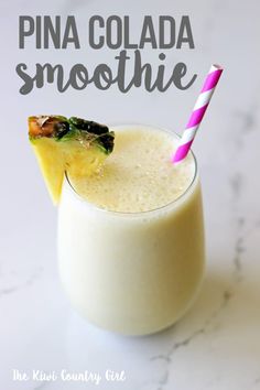 pina colada smoothie in a glass with a pink and white striped straw