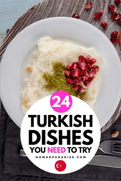 a white plate topped with mashed potatoes and pomegranate on top of a wooden table