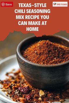 a bowl filled with chili seasoning on top of a plate next to some spices