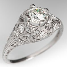 an antique style diamond engagement ring with filigrees