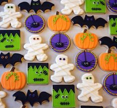 halloween decorated cookies are displayed on a table