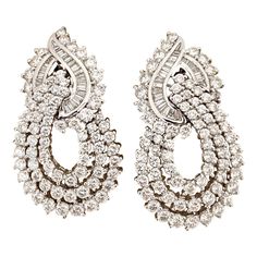 Cellini Jewelers Elegant Diamond earrings. These Platinum earrings are designed with round brilliant and baguette cut Diamonds. They are in the door knocker style and hang gracefully from the ears. They have a flexible post back making them suitable for pierced and non pierced ears. They measure 1.5" long and 0.75" wide. Total Diamond weight 7.50 carats Stamped P 900 Round Diamond Earrings, Platinum Earrings, Diamond Jewelry Designs, Door Knocker, Hanging Earrings, Pearl Earrings Dangle, Antique Earrings, Fantasy Jewelry, Baguette Cut