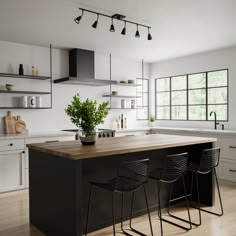 a kitchen with two bar stools next to an island