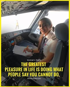 a woman pilot sitting in the cockpit of an airplane with a notepad on her lap