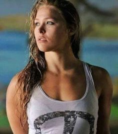 a woman with long hair wearing a tank top