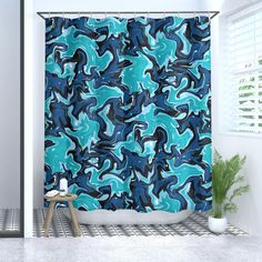 a bathroom with a blue and black shower curtain