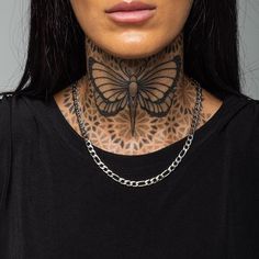 a woman with tattoos on her neck and chest