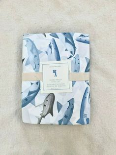 a blue and white fabric with sharks on it