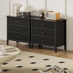 a black dresser with two drawers and a lamp on top of it in a living room