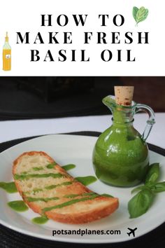 a plate with bread and pesto on it next to a bottle of basil oil