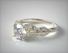 a white gold engagement ring with an oval cut diamond