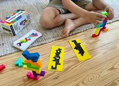 a young child playing with blocks on the floor