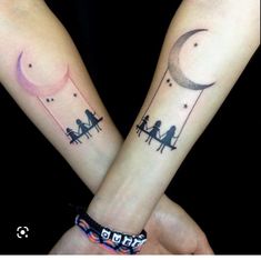 two people sitting on a bench under the moon and stars tattoo designs on their hands