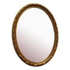 an oval mirror with ornate gold frame