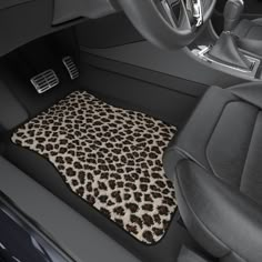 the interior of a car with a leopard print floor mat