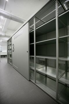 an empty room with metal shelving in it