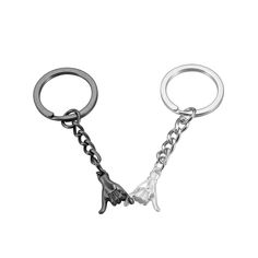 a metal key chain with two hands on it