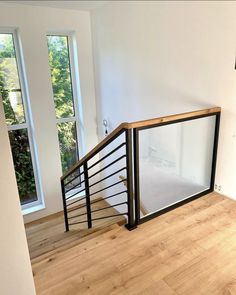 an empty room with wooden floors and railings