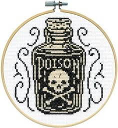 a cross stitch pattern with a bottle and skull on the front, in black and white