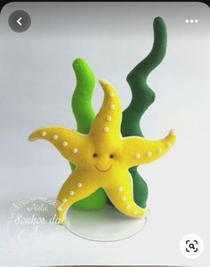 a yellow starfish sitting on top of a green plant