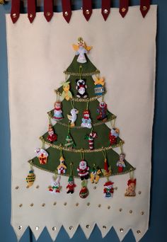 a felt christmas tree hanging on a wall