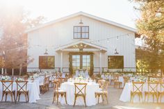 an outdoor wedding venue with tables and chairs