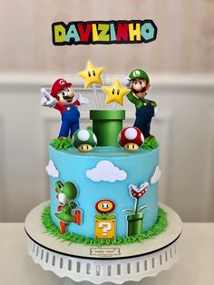 there is a cake with mario and luigi on the top, along with other decorations