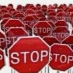 a large group of red stop signs with the word stop painted on them