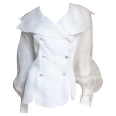 A gorgeous white silk organza blouse, shirt, top by Emmanuelle Khanh. It is double breasted with large mother of pearl buttons and a large notched portrait collar. The long, full raglan sleeves have french cuffs with matching mother of pearl cuff links. Gorgeous. Appears unworn. Fits sizes Medium. Bust 41" Sleeves from underarm 21" Length 24" Shirts For Women Stylish, Suit And Dress, Feminine Tops, Women Work Blouse, White Silk Blouse, Business Casual Dress, White Cotton Blouse, Organza Blouse, Trad Goth