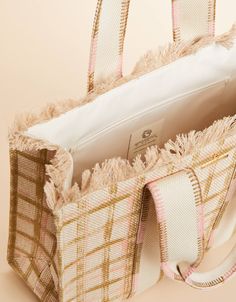 Made in a luxurious cotton and jute blend, our Fringe Tote boasts a gorgeous pink and neutral plaid to transition you into Spring. Inside its open top, you'll find a slip pocket in this medium size and roomy tote. Women's Fringe Tote Calm Waters Plaid in Tan by Spartina 449 Natural Tote Beach Bag With Fringe, Everyday Tote Bag With Fringe, Everyday Fringe Tote Bag, Beige Fringe Tote Shoulder Bag, Rectangular Pink Handwoven Bucket Bag, Spartina 449, Open Top, Calm Water, Medium Size