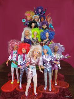 the barbie dolls are all lined up on top of each other in front of a pink background