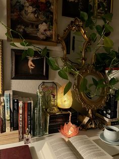 an open book sitting on top of a table next to a vase filled with flowers