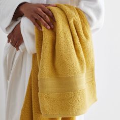 a person holding a yellow towel in their hand