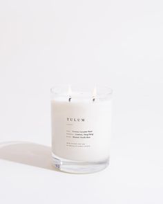 a white candle sitting on top of a table