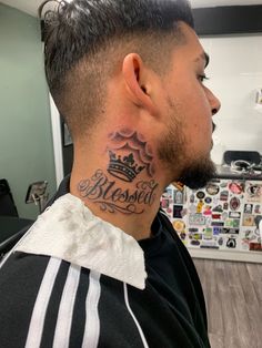 a man with a crown tattoo on his neck