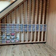 the shelves are filled with dvds and magazines on them, along with other storage items