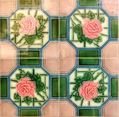 some tiles with pink roses and green leaves on them