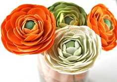 an arrangement of paper flowers in a vase