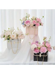 three different types of flowers in vases on a table